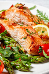 grilled salmon fillets with lemon, bacon,vegetables