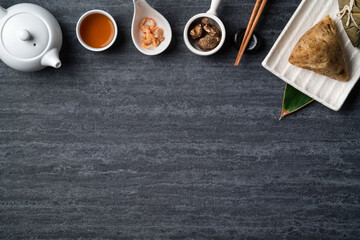 Zongzi. Rice dumpling top view for Dragon Boat Festival over dark black background.