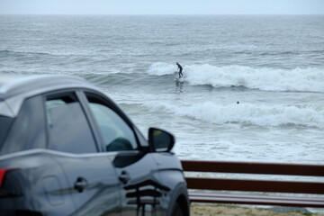 Naklejka premium Some surfers enjoying big waves at la Govelle surf spot on the french Atlantic shore. France, city: Batz-sur-mer, the 9th may 2021.