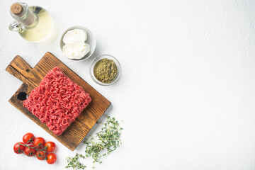 Obraz na płótnie Canvas Minced meat mixture for meatballs and ingredients, on white stone background, top view flat lay, with copy space for text