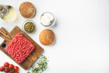 Raw minced meat with pepper, herbs and spices for cooking Meatball burger, on wooden cutting board, on white stone  background, top view flat lay, with copy space for text