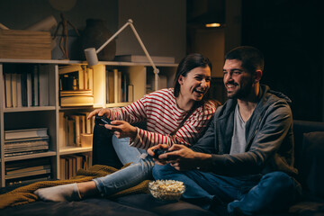 couple relaxing at home playing video games