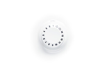 Close up view of washing machine cycle program mode switch handle selector knob wheel with digits around and two icons (spin and drain) isolated on the bright solid fond plain clean white background