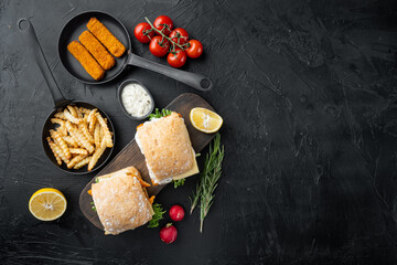 Fish fingers sandwich , on wooden cutting board, on black background, top view flat lay , with copyspace  and space for text
