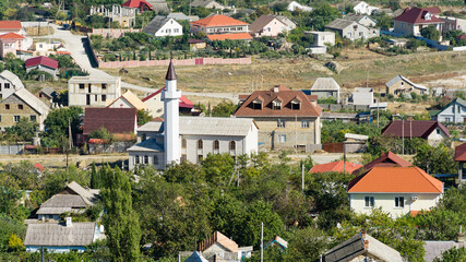 Fototapeta premium Veseloe village near Sudak. View of village on the Black Sea coast on sunny autumn day. Veseloe, Crimea, Russia – October 1, 2019