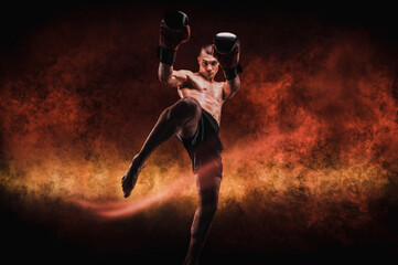 Image of a kickboxer in a fiery arena. Knee kick. Mixed martial arts.