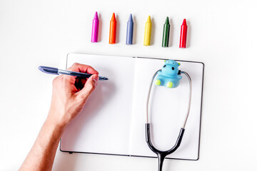 children's doctor work with stethoscope and markers white background top view mock-up