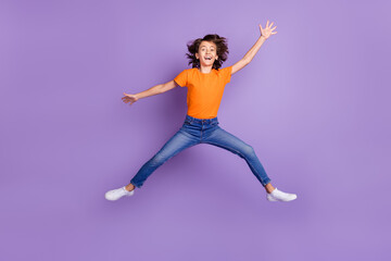 Fototapeta na wymiar Full length body size view of attractive funky cheerful boy jumping fooling isolated over violet purple color background