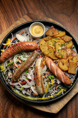 mixed german traditional organic sausage and potato meal platter