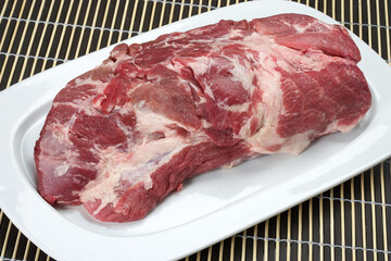 raw beef steak on a white tray