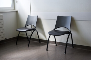Closeup of black chairs in a waiting room