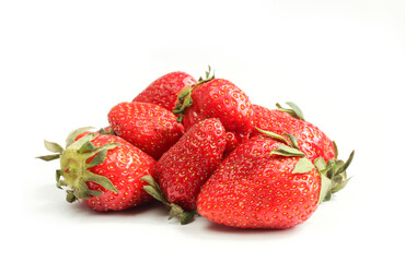 Group of red strawberries with green leaves isolated on white background. 