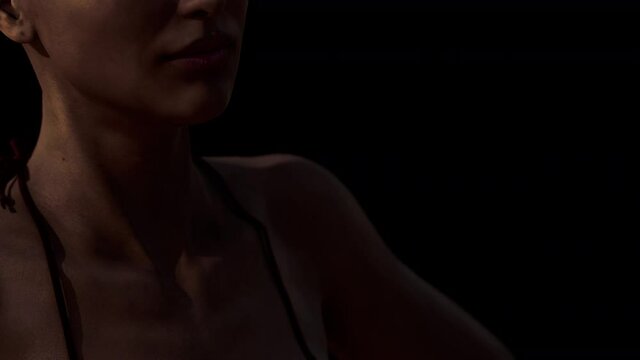 Beautiful bikini woman in the dark