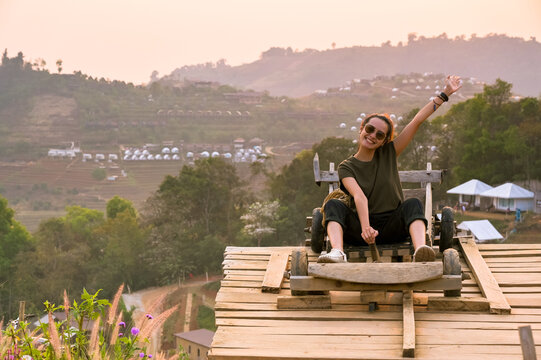 Young women sitting on wooden car and having enjoy moment , freedom and recreation concept