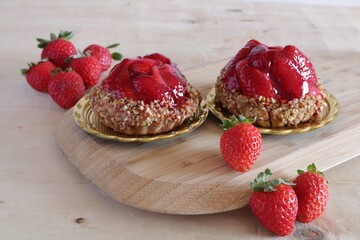 Selective focus of two strawberries tart dessert on wood background