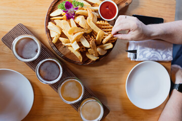 Man sampling variety of seasonal craft beer in pub. Beer samplers in small glasses individually...
