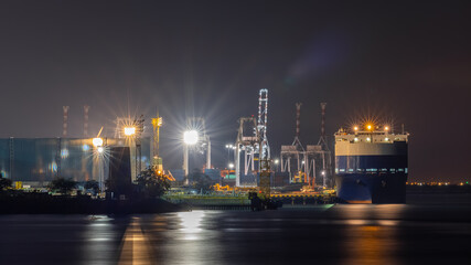 Fototapeta na wymiar night scene shot shipping port and factory