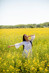 Young woman in the rapeseed field