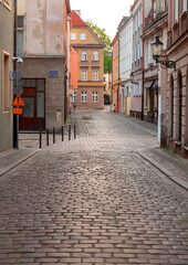 Poznan. Old traditional narrow city street at sunrise.