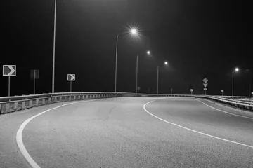  Black and white photo of an empty country road with street lights © VeNN