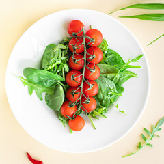 tomato cherry salad green leaves fresh mix greens spinach, arugula, lettuce ingredient on the table healthy food meal snack copy space food background rustic keto or paleo diet veggie 