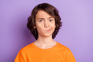 Fototapeta premium Portrait of nice unsure boy creating solution overthinking smirk isolated over violet purple color background