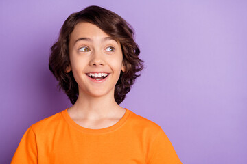 Portrait of nice amazed cheerful toothy boy creating solution copy space isolated over violet...