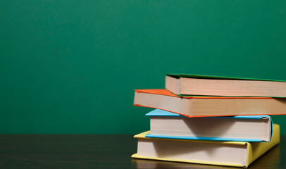 Composition with vintage old hardback books, colored background.