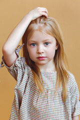 portrait of a little fashionable girl in the studio