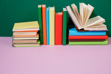 Composition with vintage old hardback books, diary, fanned pages on wooden deck table