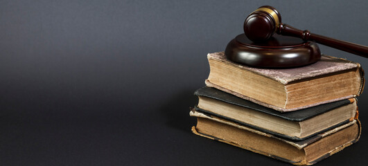law book with a wooden judges gavel on table