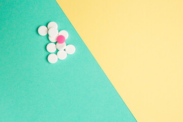 White and pink medicines on a colored background
