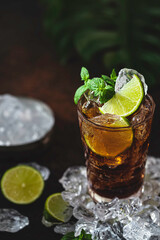 Cuba Libre with brown rum, cola, mint and lime. Cold Longdrink, alcohol cocktail.