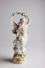 vintage porcelain figurine of a girl isolated on white background