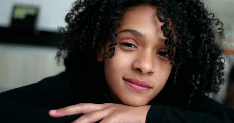 Preteen girl looking at camera smiling. Cute little child smile