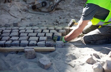 Road repairs, installation of a new sidewalk made of ancient cobblestones