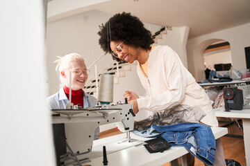 Woman critically looking at the sewing machine and smiling