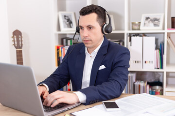 Fototapeta premium Working at home with a laptop and looking at the phone. Business meetings and conferences.