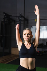 Fototapeta na wymiar sportswoman with amputated forearm exercising in sports center