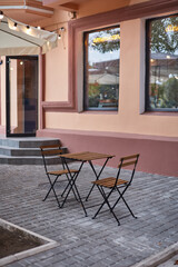 table and chairs on the terrace empty street cafe with garden