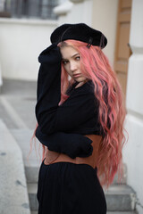 a pensive girl with pink hair in a black beret, a wide light brown leather Basco belt