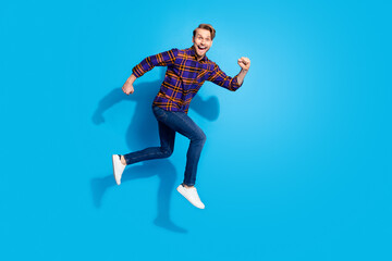 Fototapeta na wymiar Full body profile portrait of carefree crazy man open mouth look camera isolated on blue color background