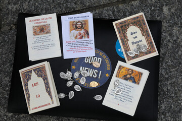Street evangelizers' pamphlets and medals in Paris, France.