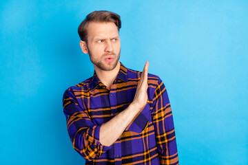 Portrait of attractive suspicious man showing aside palm no disagree decline isolated over bright...