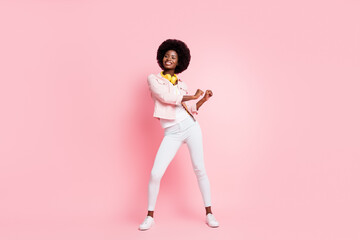 Full length body size view of pretty skinny cheerful girl listening hit pop enjoying dancing isolated over pink color background