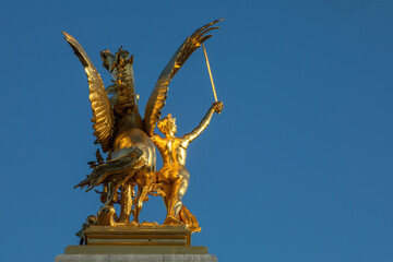 Fototapeta na wymiar Statue on Alexander III bridge, Paris, France.