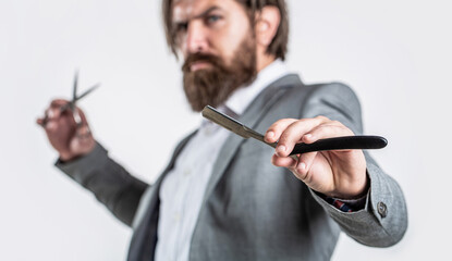 Barber scissors and straight razor, barber shop, suit. Vintage barber shop, shaving. Bearded client visiting barber shop. Portrait bearded man. Vintage barbershop