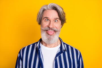 Photo of happy excited funky funny smiling mature man showing tongue fooling around isolated on...