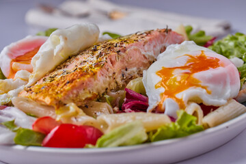 Baked salmon fillet with poached eggs.