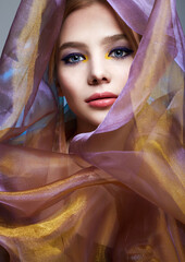 beautiful young woman in color veil. colorful make-up girl